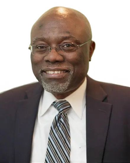 Portrait of Dr. Eustace Lashley, MD, wearing glasses, a suit and tie