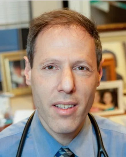 Portrait of Dr. Howard Antosofsky, MD, wearing a stethoscope in his office