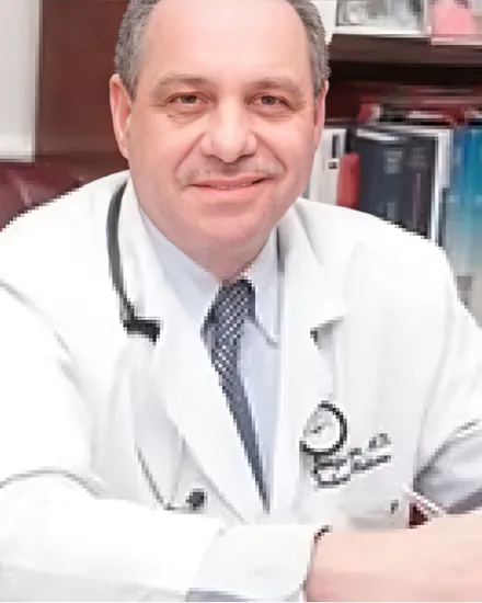 Portrait of Dr. Jorge Serje, MD, wearing glasses, a suit and tie