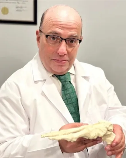 Portrait of Dr. Salvatore Gaudino, DPM, in a white coat